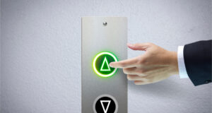 Male hand pressing green lift button