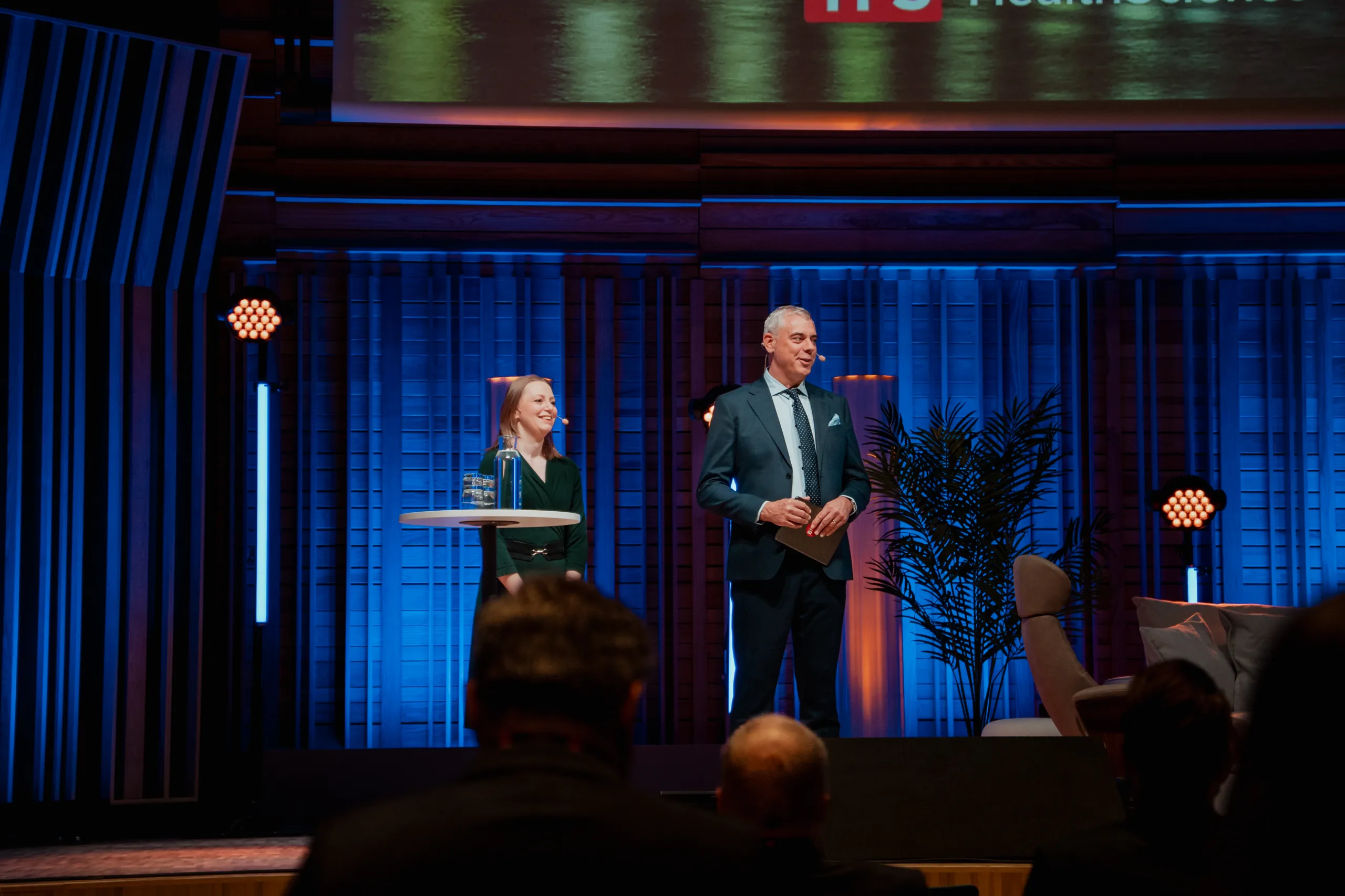 Cecilia and Jonas, CEO of Biostock laughing at stage.
