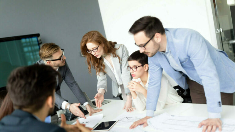 Team discussing business in grey office