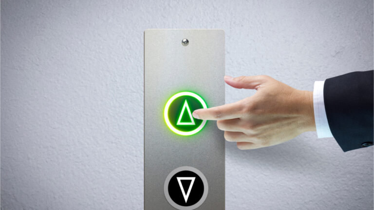 Male hand pressing green lift button