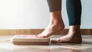 Woman stands on a scale