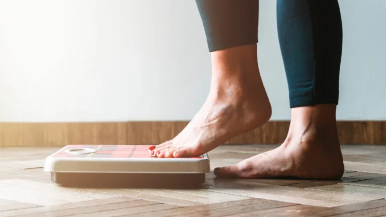 Woman stands on a scale